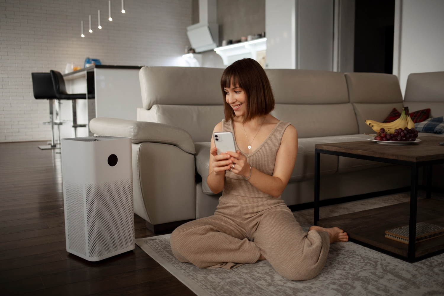 Smiling woman using phone next to smart air purifier in lounge