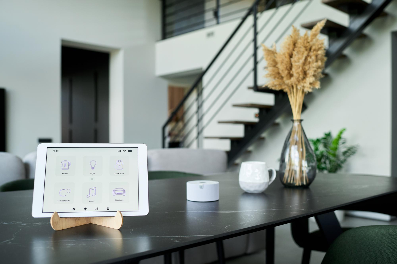 Smart home dashboard tablet on modern black dining table